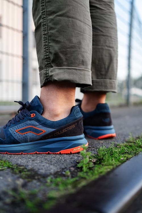 Person in Blue Sneakers Standing on the Ground