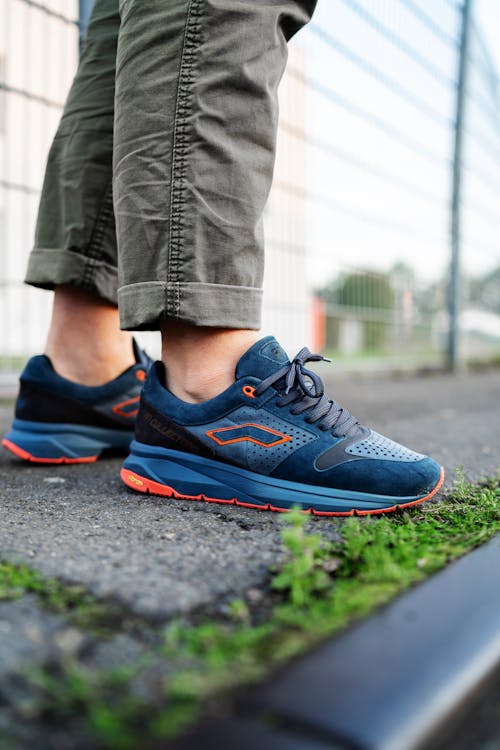  Person in Blue Sneakers Standing on the Ground