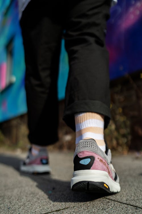 A Person Wearing a Pair of Sneakers