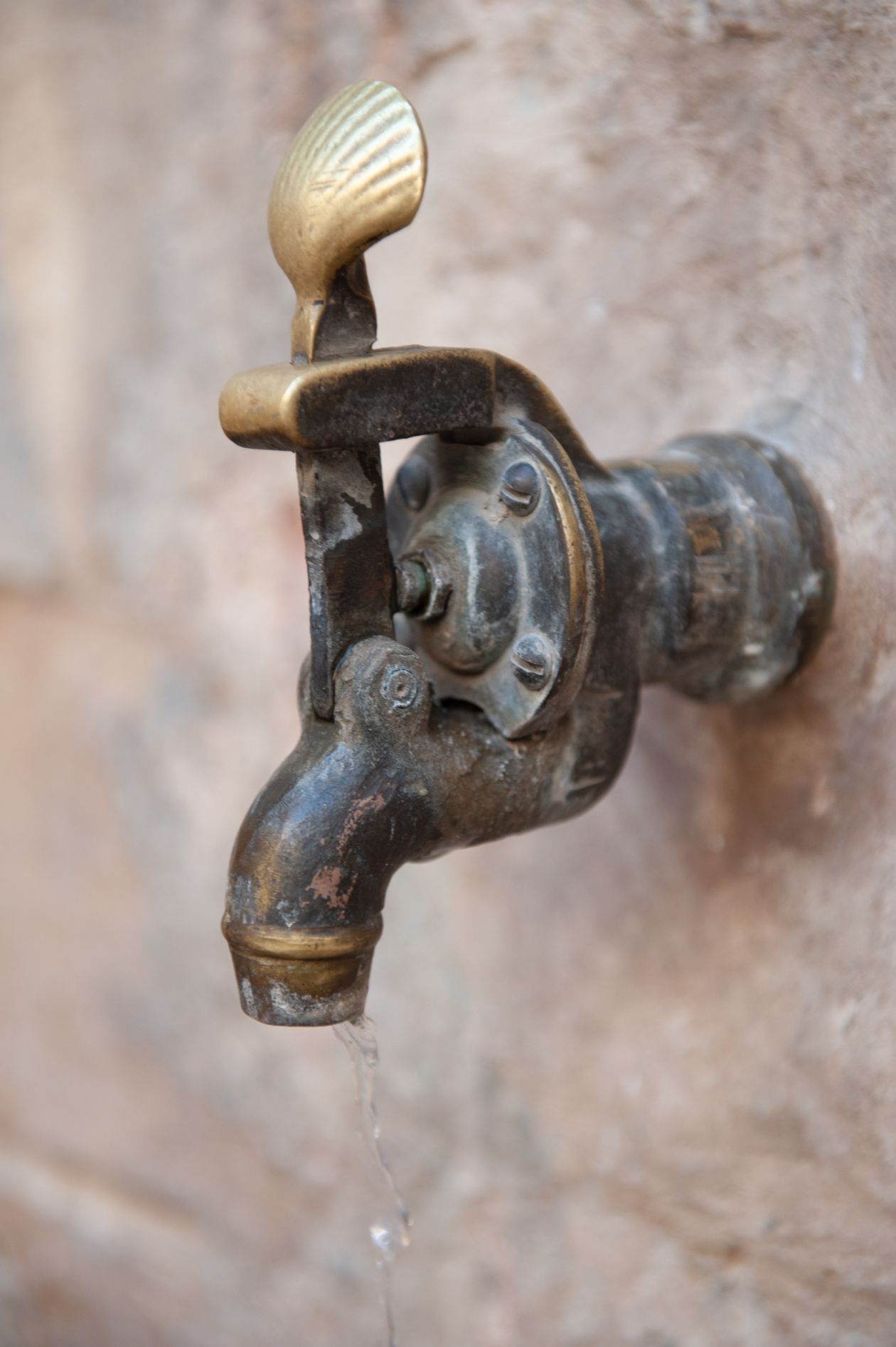 Antique brass faucet with running water
