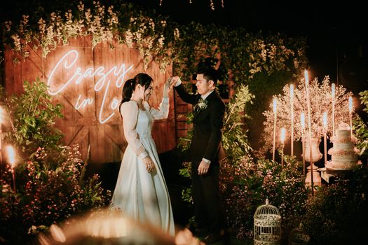 Newlywed Couple Holding Each Other's Hands
