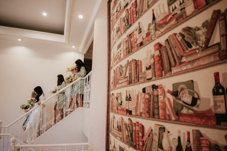 Group Of Women Walking Down Stairs At Exhibition House