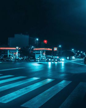 A vibrant night scene capturing cars and a crosswalk in Rabat.
