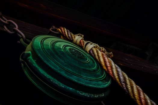 A vintage green pulley with rustic chain and rope adds an industrial charm.