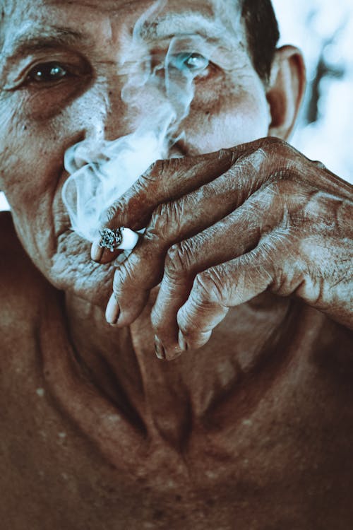 Free An Elderly Man Smoking a Cigarette Stock Photo
