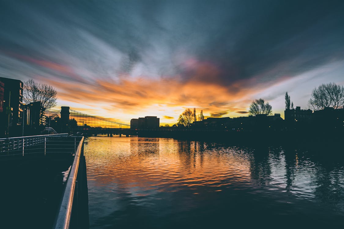 High Rise Buildings Near Body of Water during Golden Hour