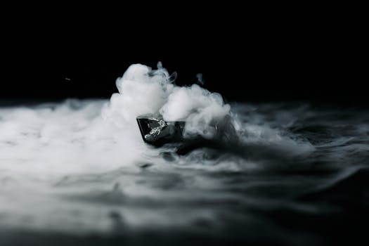 A small boat appears enveloped in dramatic smoke against a deep black background.