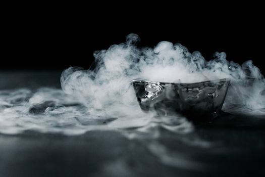 Captivating image of smoke wafting from a sleek glass bowl, creating an enigmatic atmosphere.