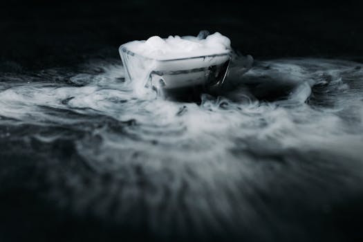 A glass bowl shrouded in swirling mist creates an enigmatic and ethereal atmosphere.