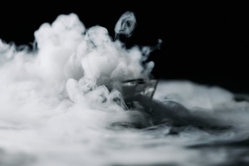 A Thick White Smoke Against Black Background