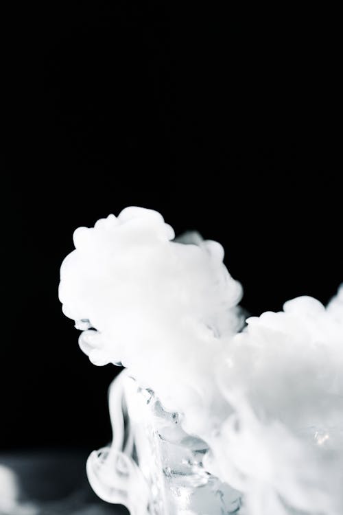 A Thick White Smoke Plume Against Black Background