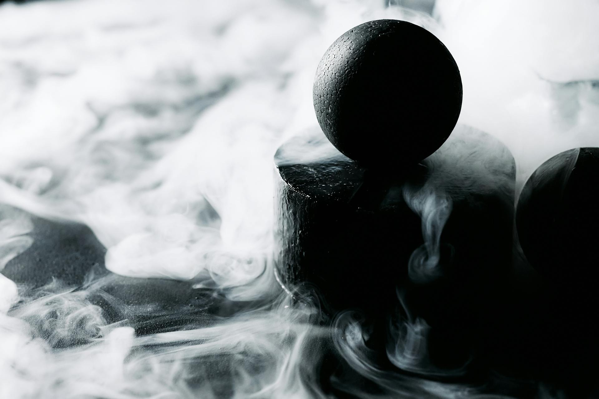 A Black Ball Surrounded by Smoke