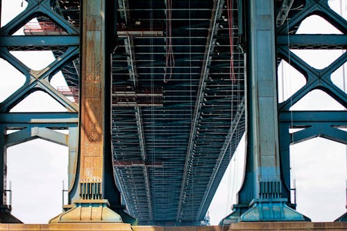 Blue Metal Bridge in Low Angle Photo at Daytime