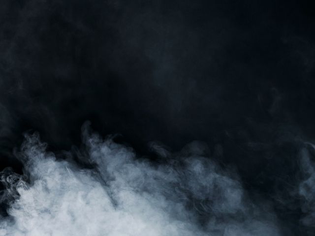 Steam rolling through a dark room
