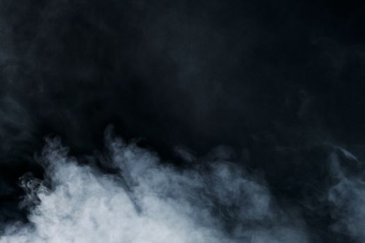 Ethereal white smoke on a black background creates a sense of mystery and depth.