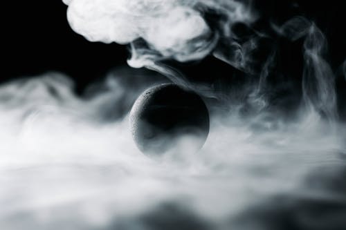 A Black Ball Surrounded by Smoke