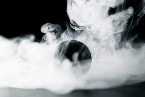 Free A Black Ball Surrounded by Smoke Stock Photo