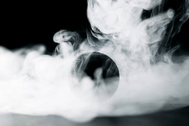 A Black Ball Surrounded By Smoke