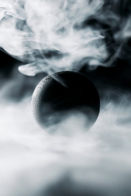 A Black Ball Surrounded by Smoke