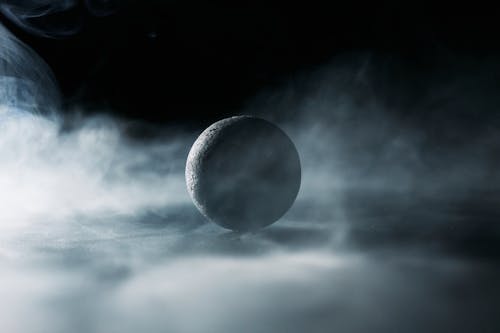 Free A Black Ball Surrounded by Smoke Stock Photo