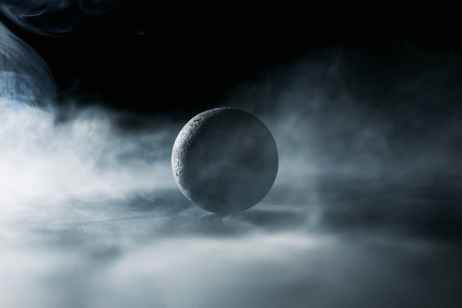 A solitary sphere emerges through dense smoke, creating a mystic atmosphere.