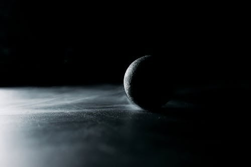 A Black Ball on Black Surface