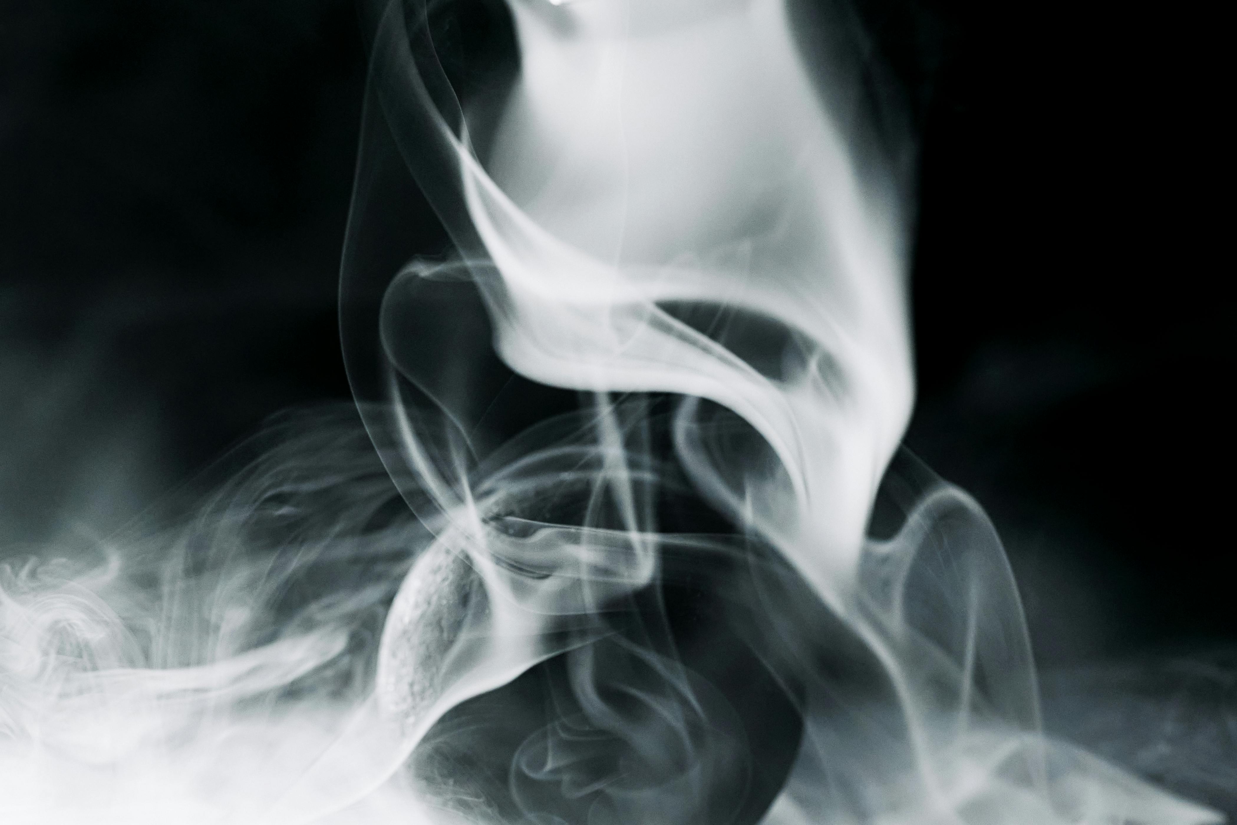 a black ball surrounded by smoke