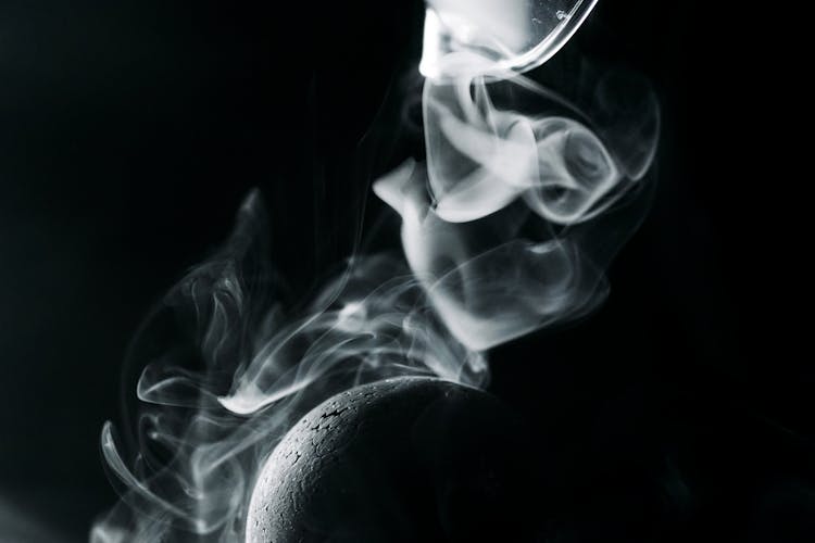 Close-Up Photo Of Black Ball Against White Smoke