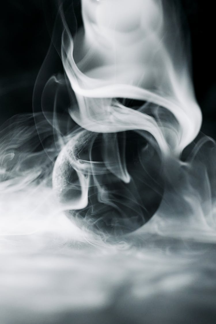 A Black Ball Surrounded By Smoke