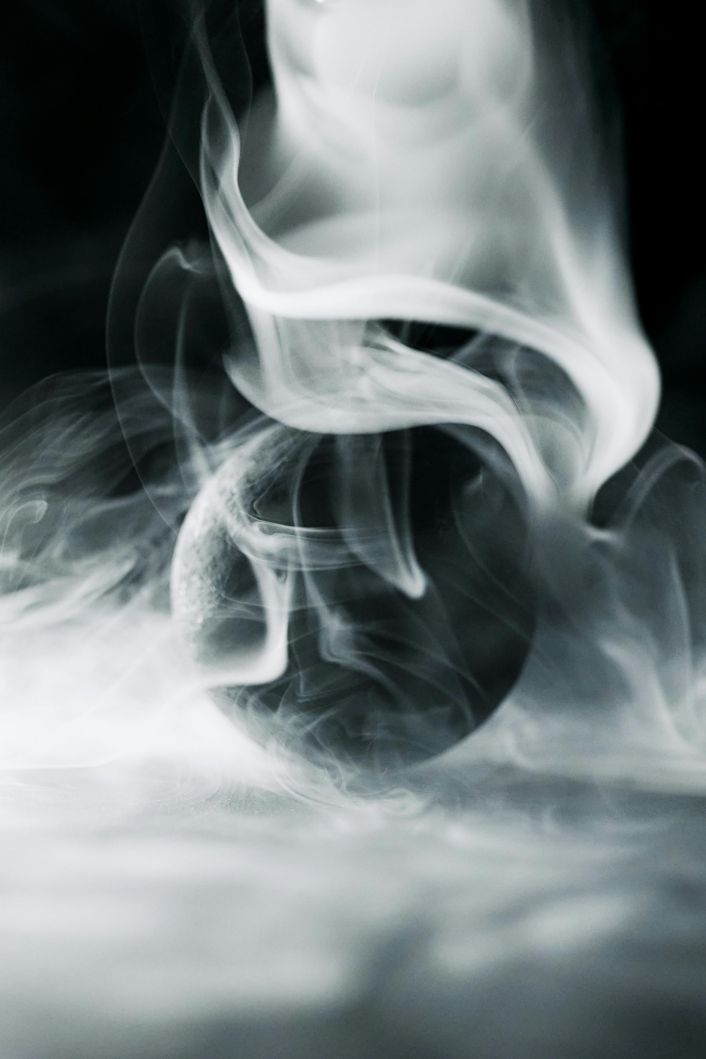 A Black Ball Surrounded by Smoke · Free Stock Photo
