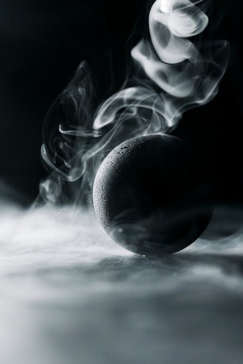 A Black Ball Surrounded by Smoke