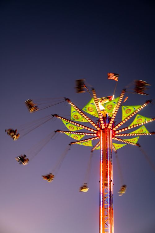 Free Vibrant carousel swings at twilight with American flag in Boise, ID. Stock Photo