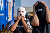 Man in Black T-shirt Covering His Face With White Knit Cap