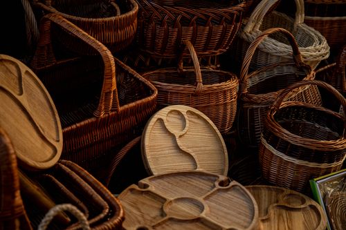 Free A collection of handcrafted wicker baskets and wooden trays showcasing rustic craftsmanship and design. Stock Photo