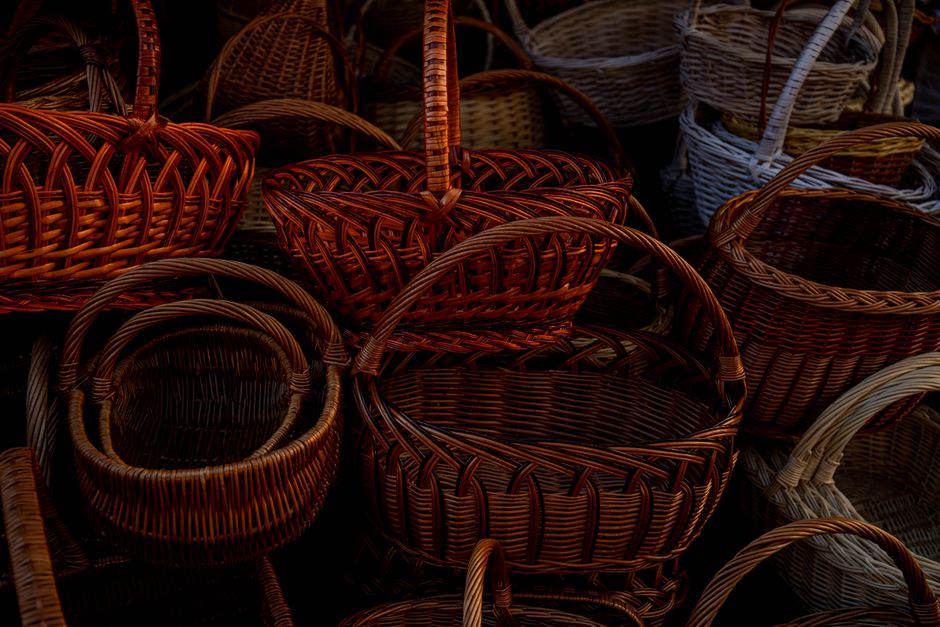 Close-up of various handcrafted wicker baskets, showcasing intricate woven designs.