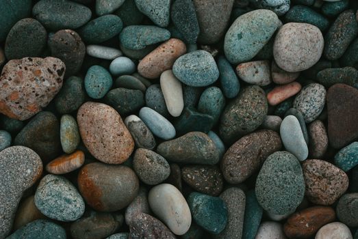 An artistic close-up photo of variously toned textured pebbles arranged together.
