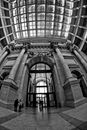 Grayscale Photo of People Walking Inside Building