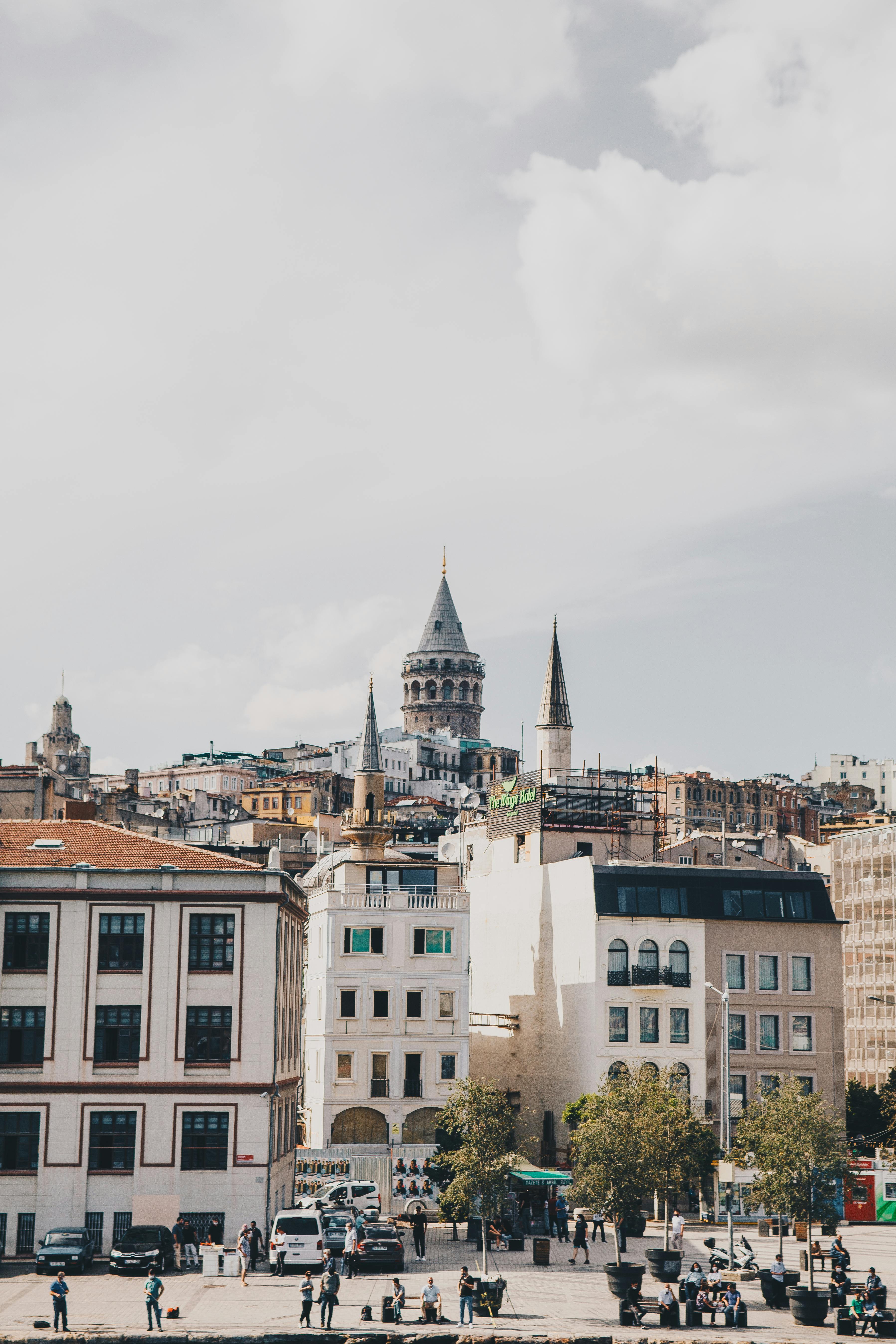 Scenic view of the iconic Galata Tower amidst Istanbul's cityscape with bustling streets below.