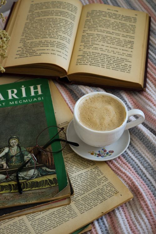 Free A warm setting with coffee and books for a relaxing reading time indoors. Stock Photo