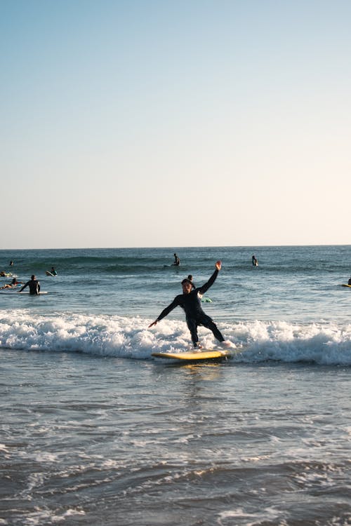 A Man Surfing on Sea Waves