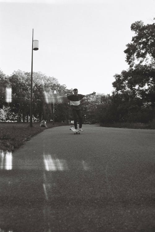 Free Grayscale Photo of a Man Skateboarding Stock Photo