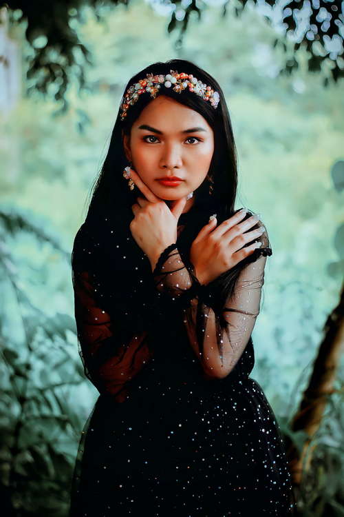 Photo of a Beautiful Woman in a Black Dress Posing with Her Hand on Her ...