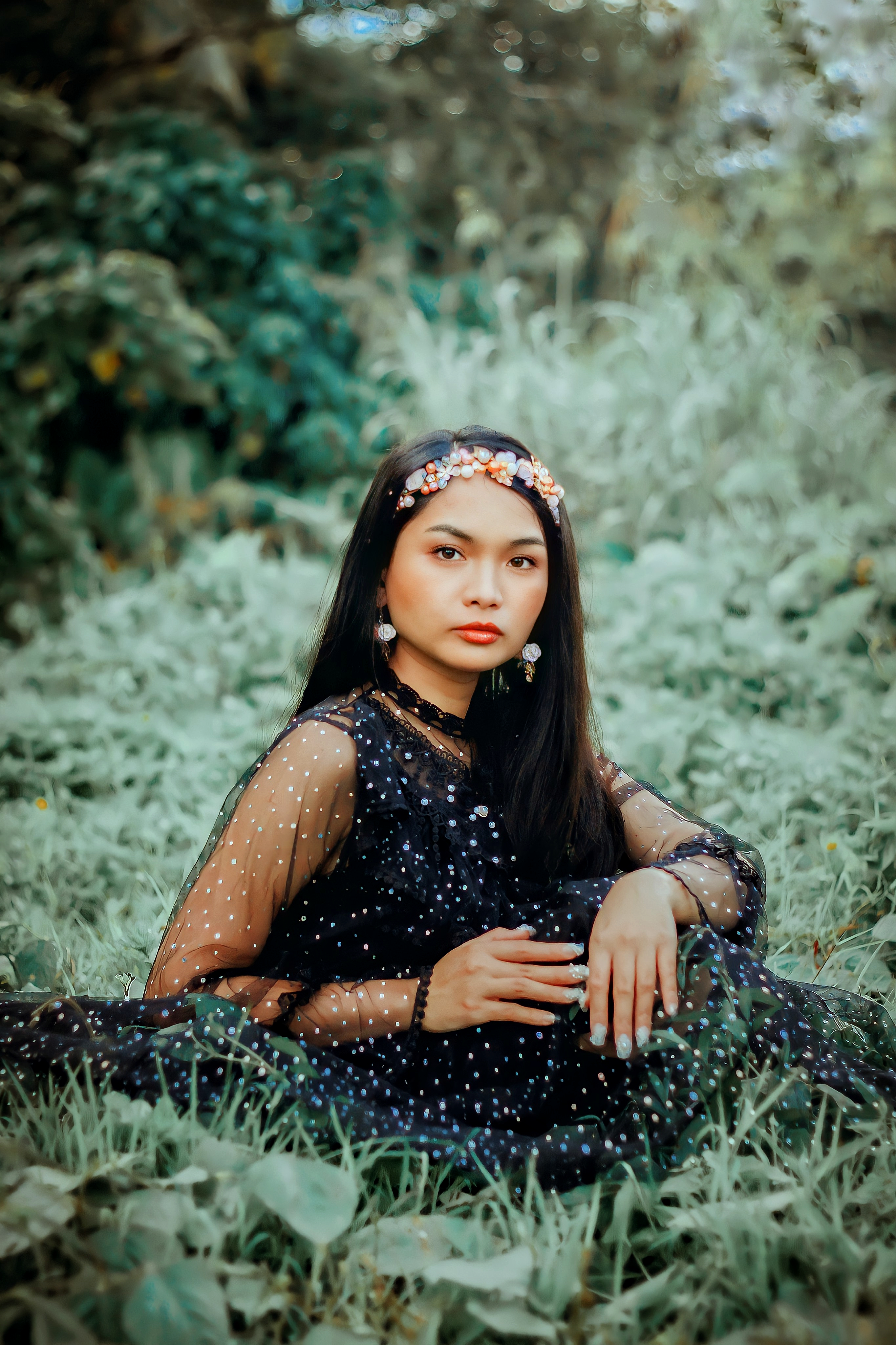 A Woman in a Black Dress Sitting on the Grass · Free Stock Photo