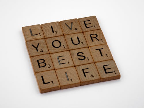 Brown Wooden Letter Blocks on White Surface