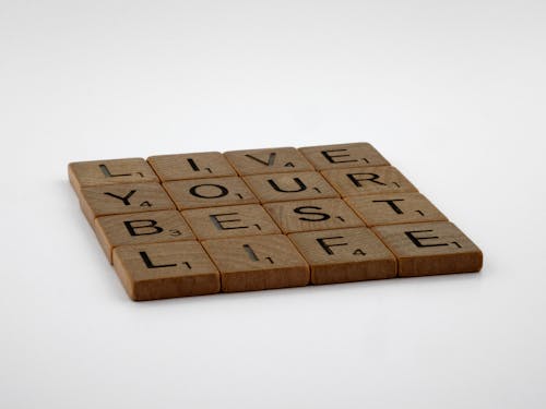 Brown Wooden Scrabble Tiles on the Table