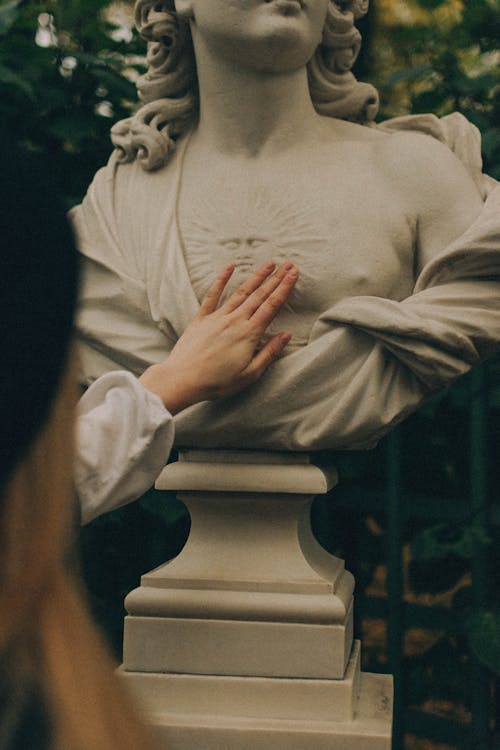 A Person Holding a Concrete Statue