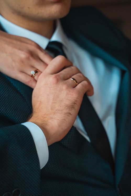 Free Intimate close-up of a couple's hands showing wedding rings, symbolizing love and commitment. Stock Photo
