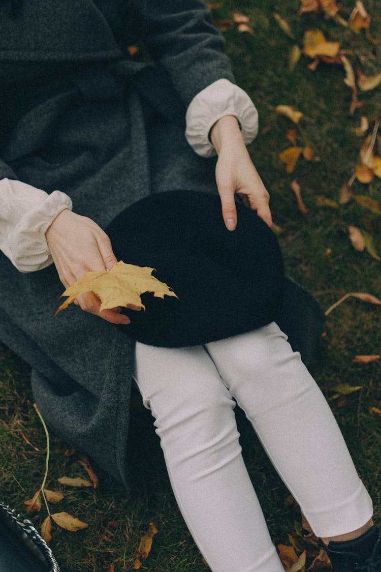 Woman Hands Holding Hat And Maple Leaf