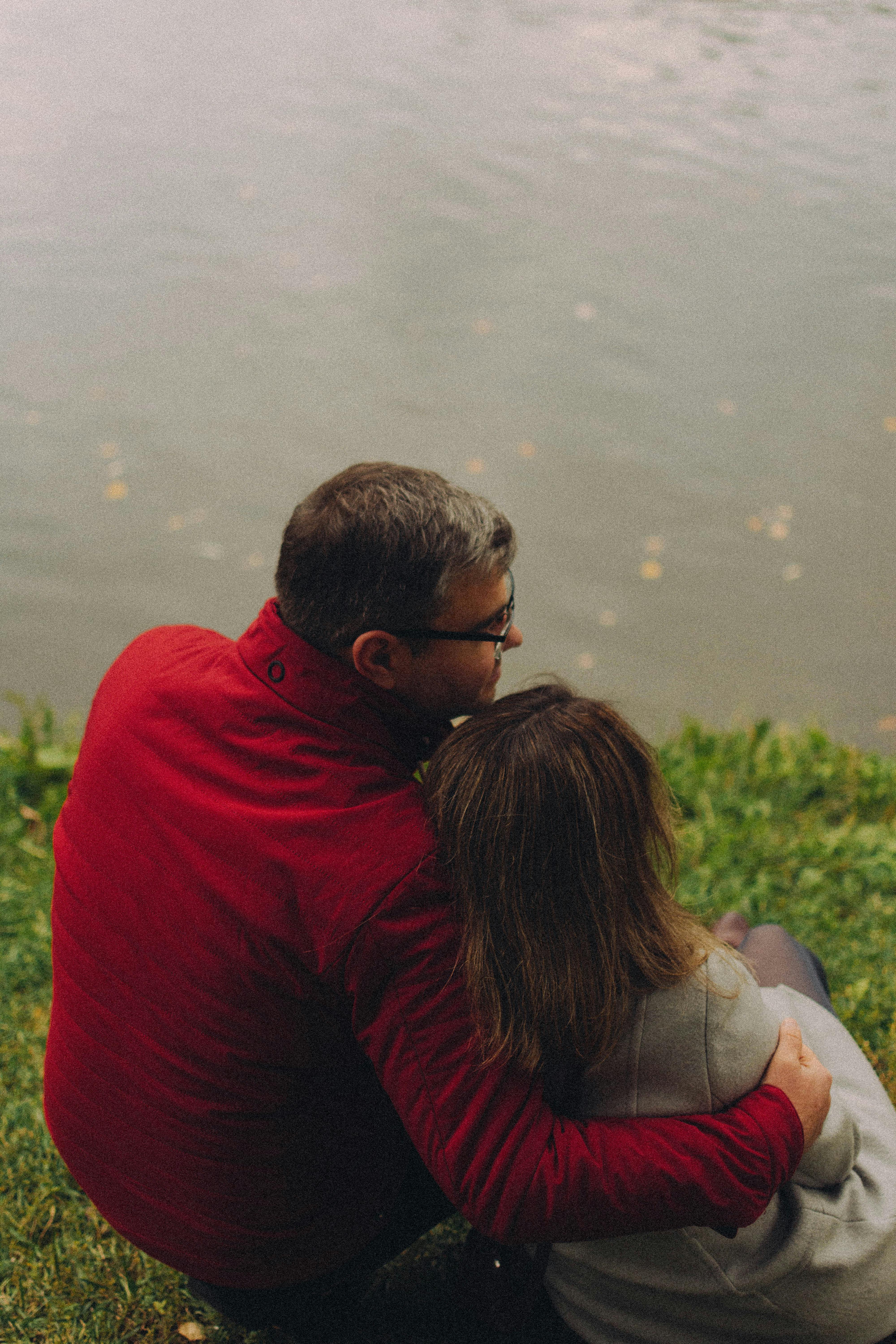 Mature Couple Sitting Together by the Water &middot; Free Stock Photo