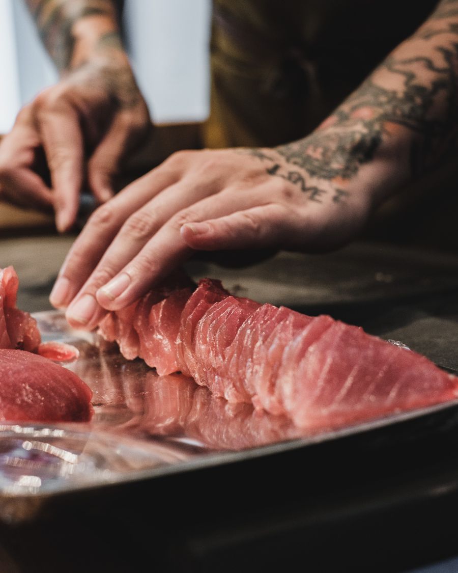 Chef preparing sushi at a counter